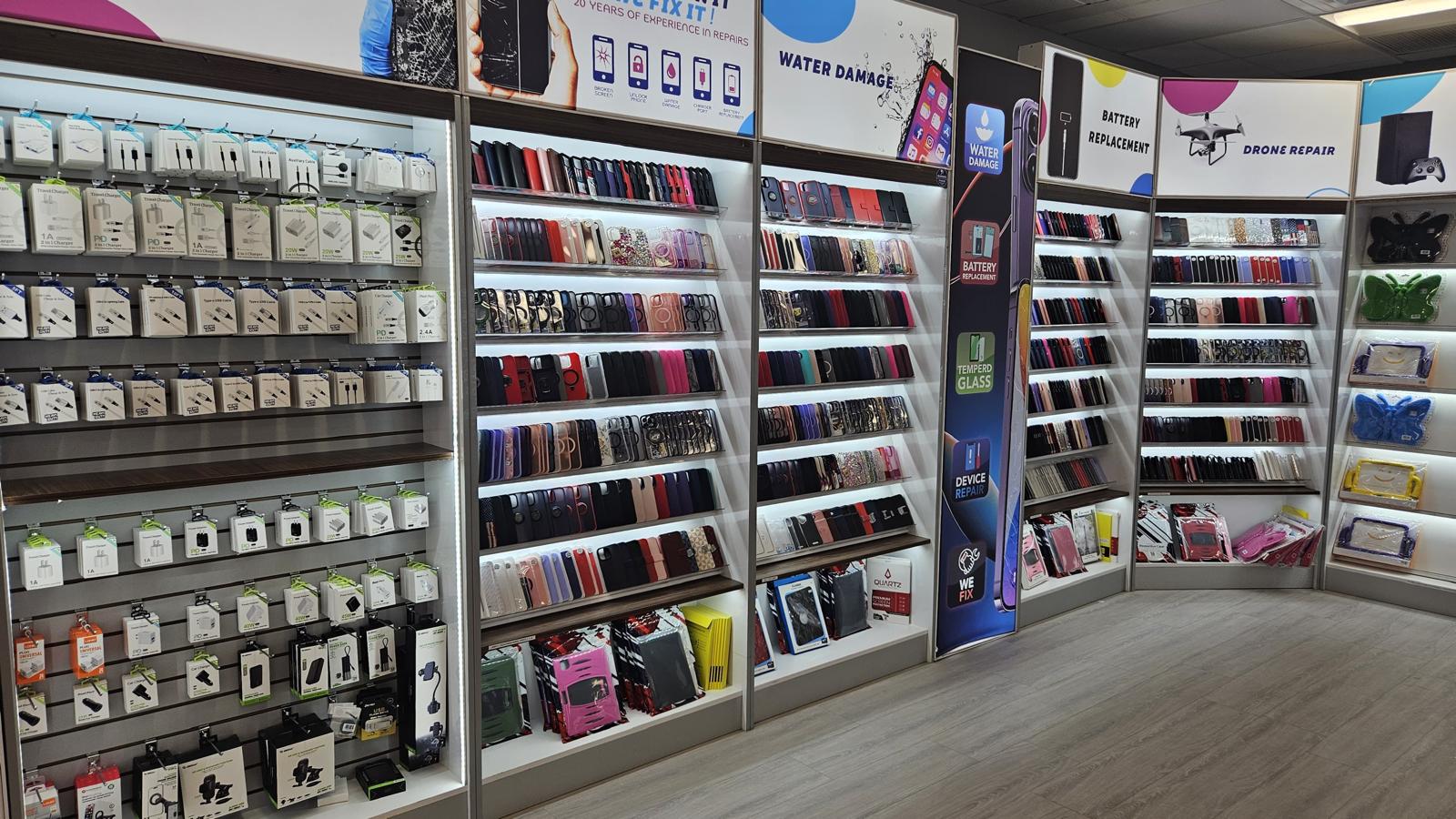 Clean and organized phone accessories wall inside Talk N' Fix repair shop